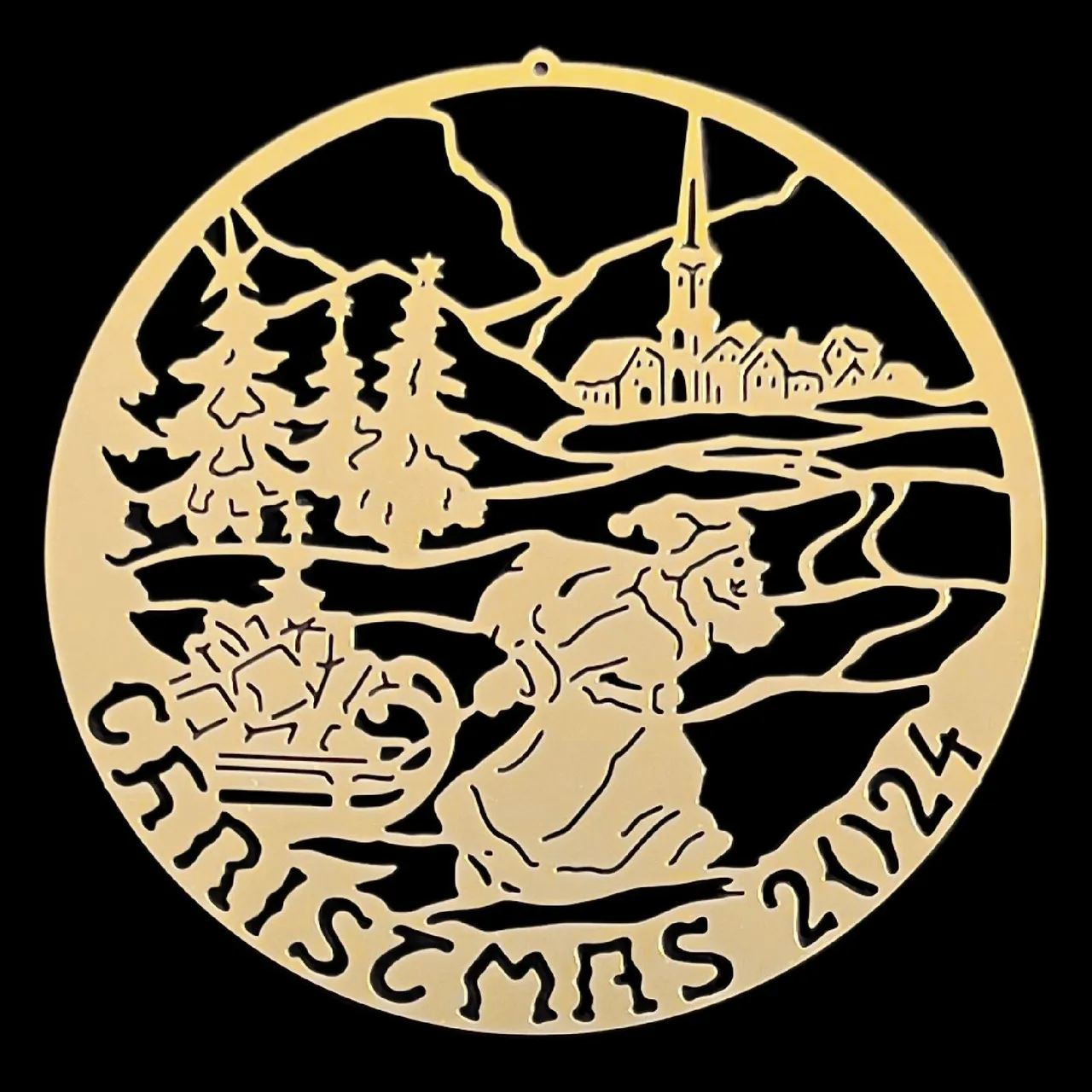 Gold Biedermann Christmas ornament depicting Santa, trees, a village, and the year 2024 on a black background